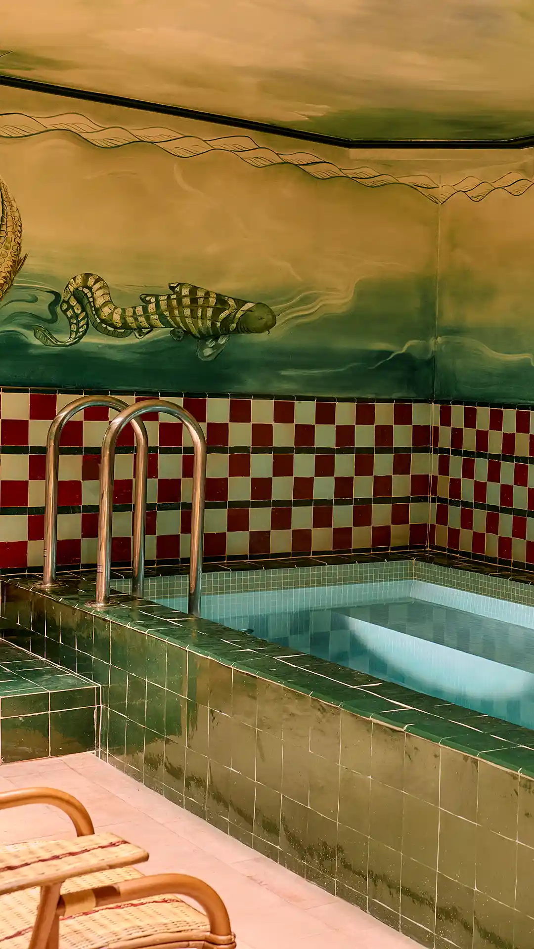 Chrome pool ladder and seahorse mural on the wall, the hotel’s spa with pool and hammam in Paris 10th
