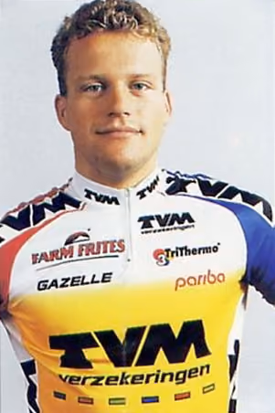 Smiling Steven de Jongh in a yellow TVM verzekeringen jersey with sponsor logos on a white background.