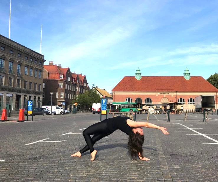 Wild Thing yoga pose (Camatkarasana) practised in a city square