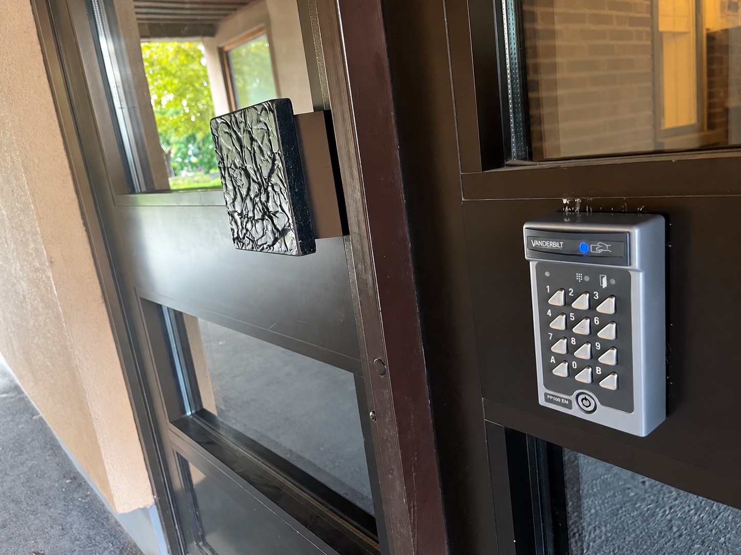 A keypad entry control mounted beside a door