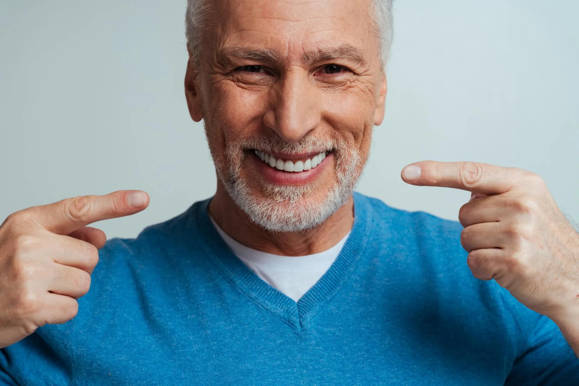 Porcelain dental crown being placed on a prepared tooth to restore strength and appearance