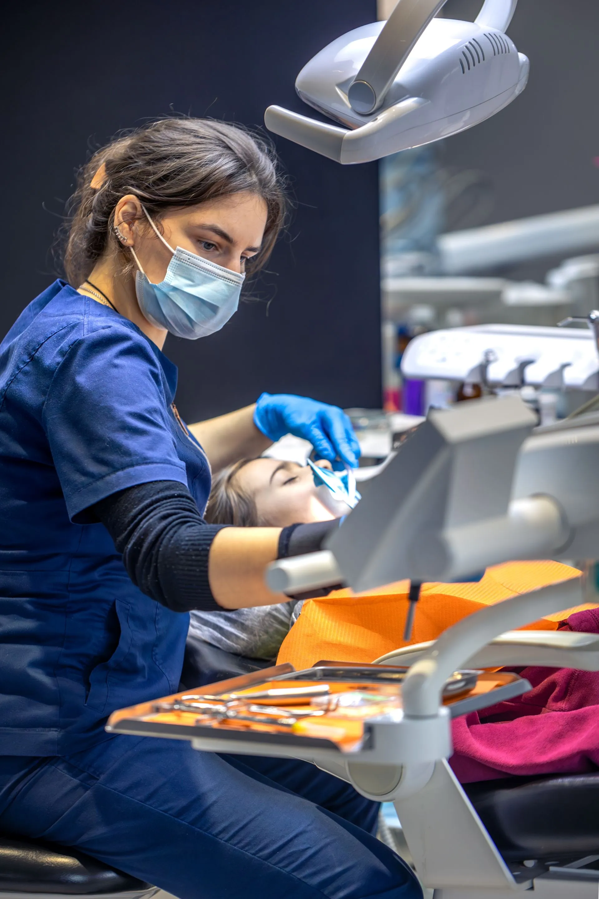Close-up of bone graft material being placed in the jawbone to restore lost bone volume