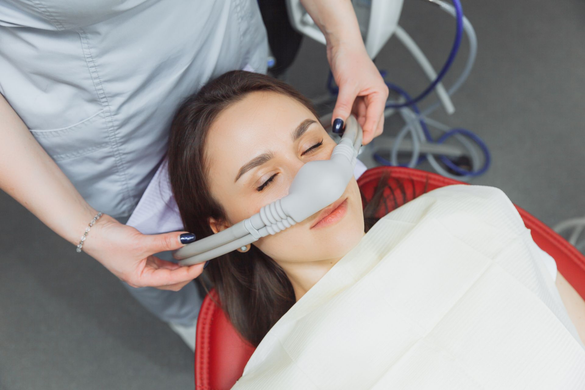 Dental team carefully monitoring a patient during a sedation dentistry procedure at Nova Dental Care of Vienna