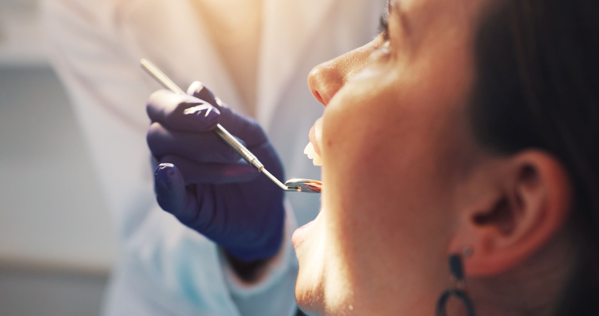 Dental hygienist performing a professional teeth cleaning on a patient at Nova Dental Care of Vienna