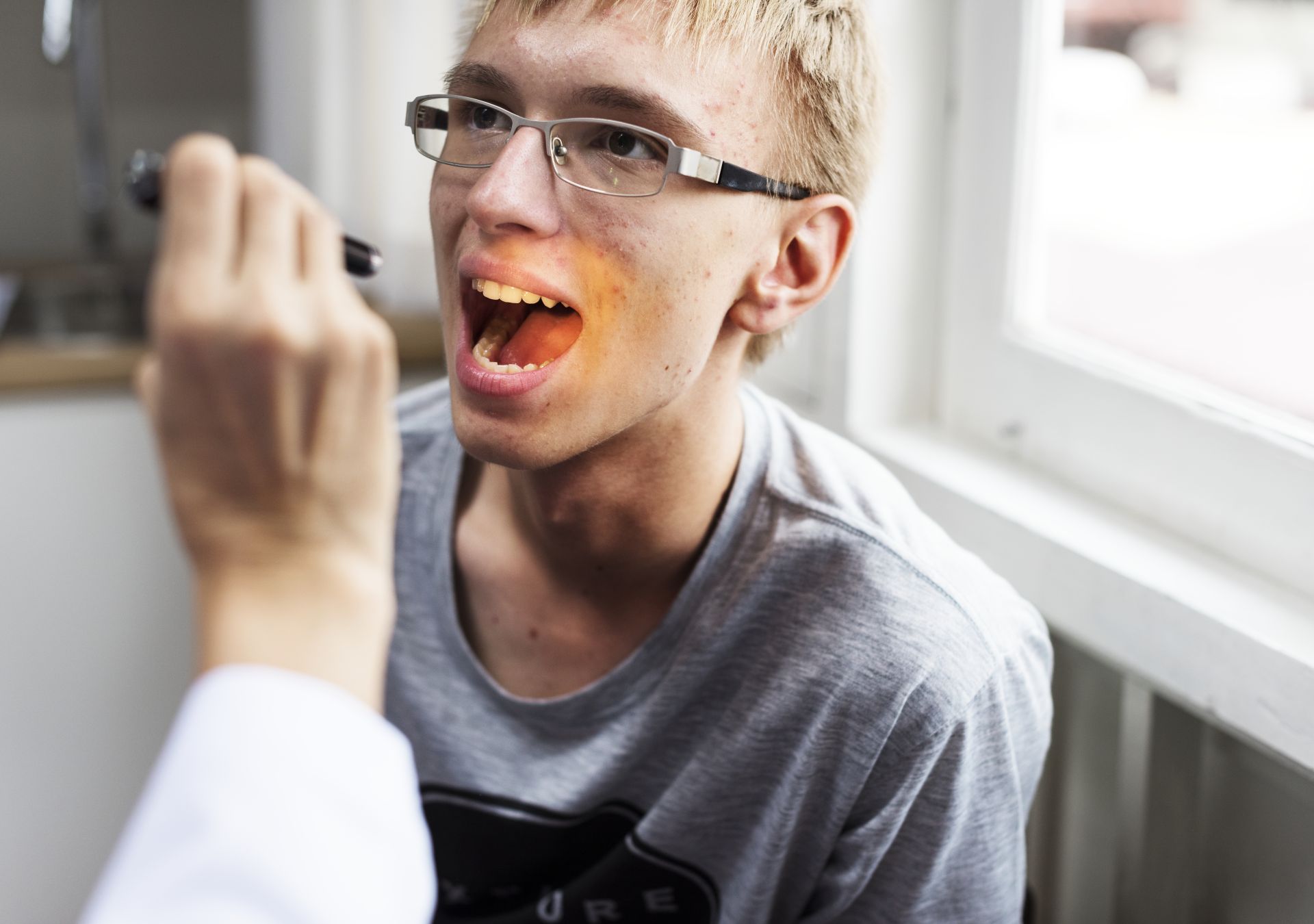 Patient receiving an oral tissue examination as part of a comprehensive dental exam at Nova Dental Care of Vienna