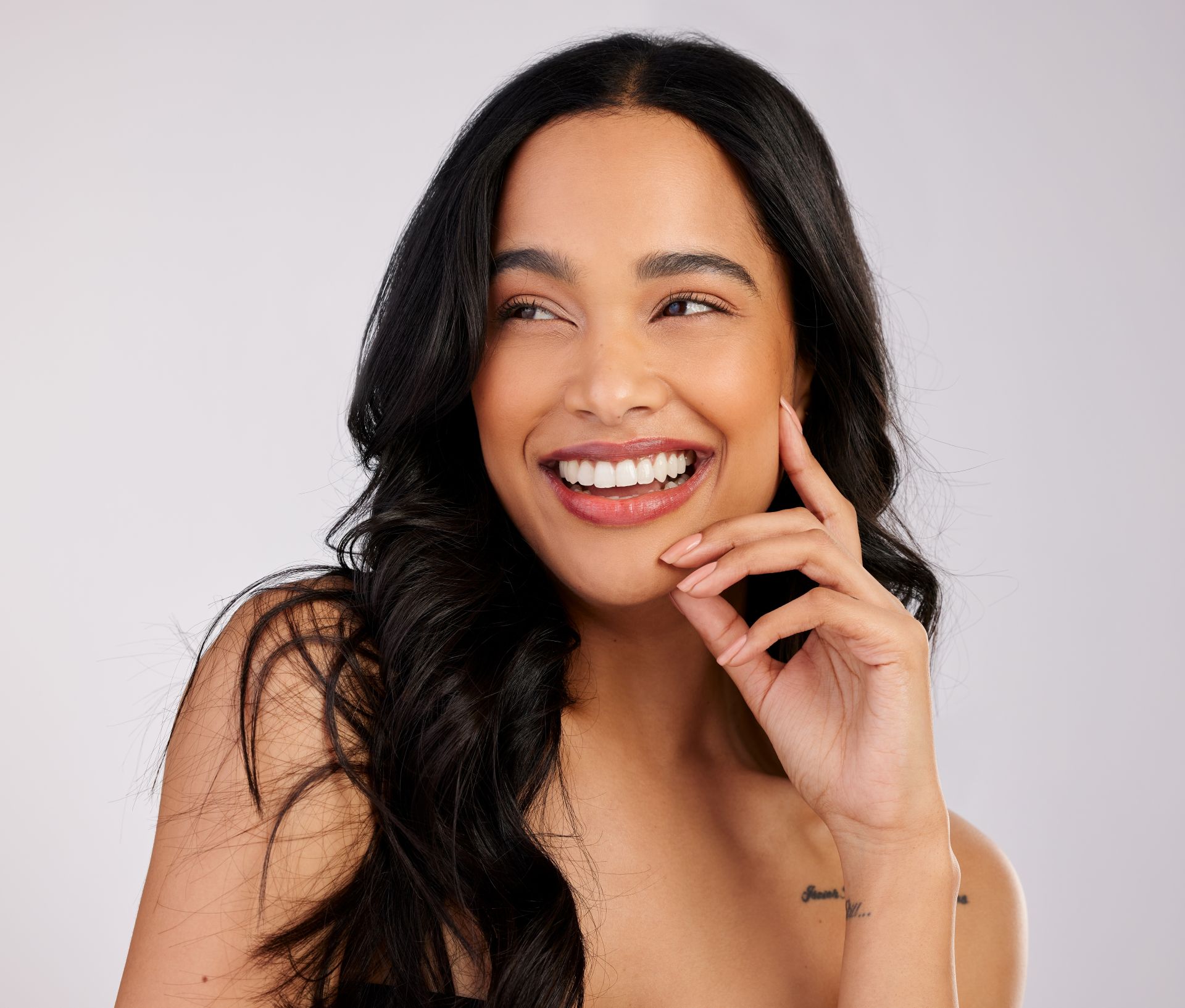 Patient smiling after gum contouring treatment that reshaped an uneven gum line at Nova Dental Care of Vienna