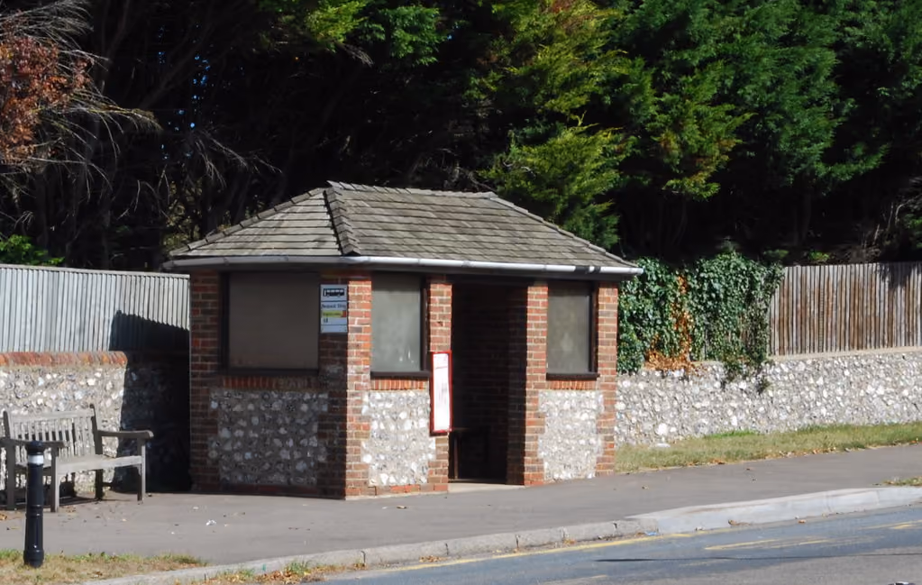 A rural bus shelter on a village road