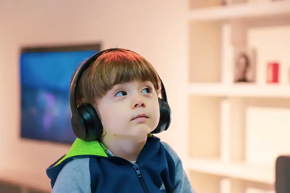 Child wearing headphones, stock image