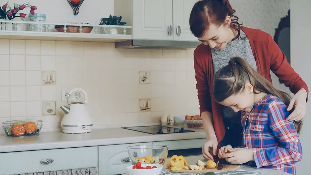 Adult and child cooking together, stock image