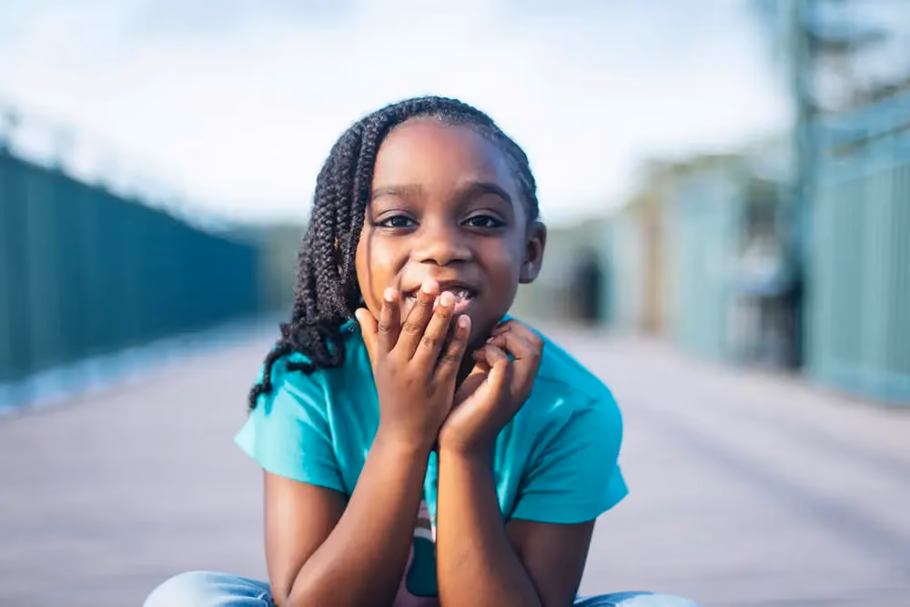 Girl with hands to her face, stock image