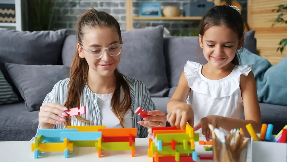 Adult and child building with blocks, stock image