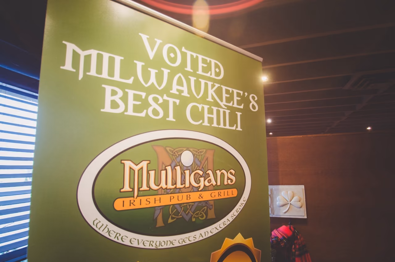Green sign for Mulligans Irish Pub & Grill, voted Milwaukee's Best Chili.