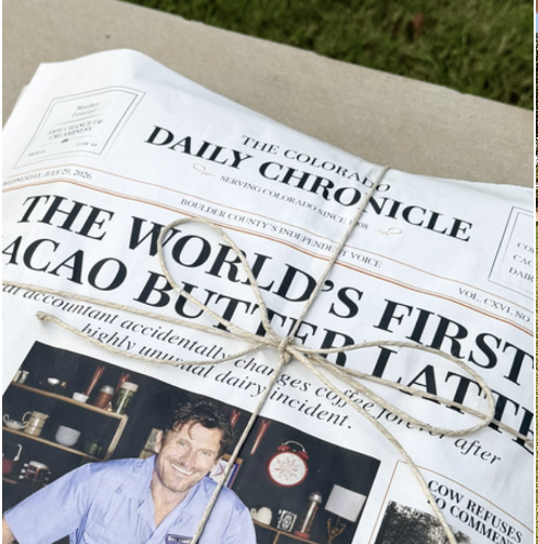 A newspaper titled The Colorado Daily Chronicle with a headline about cacao butter and a man smiling below it.