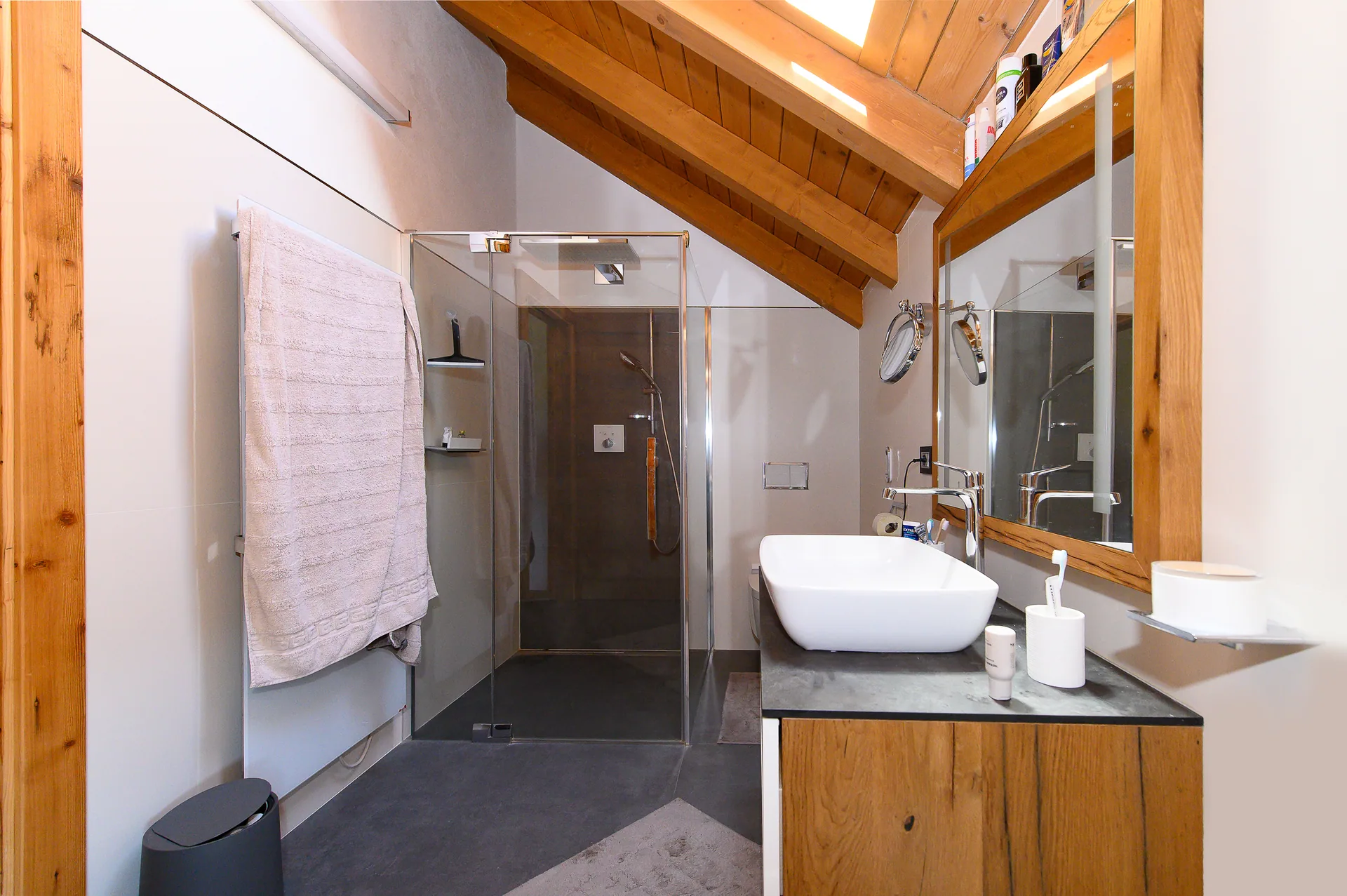 Badezimmer im Dachgeschoss mit Holzdecke und großer Dusche