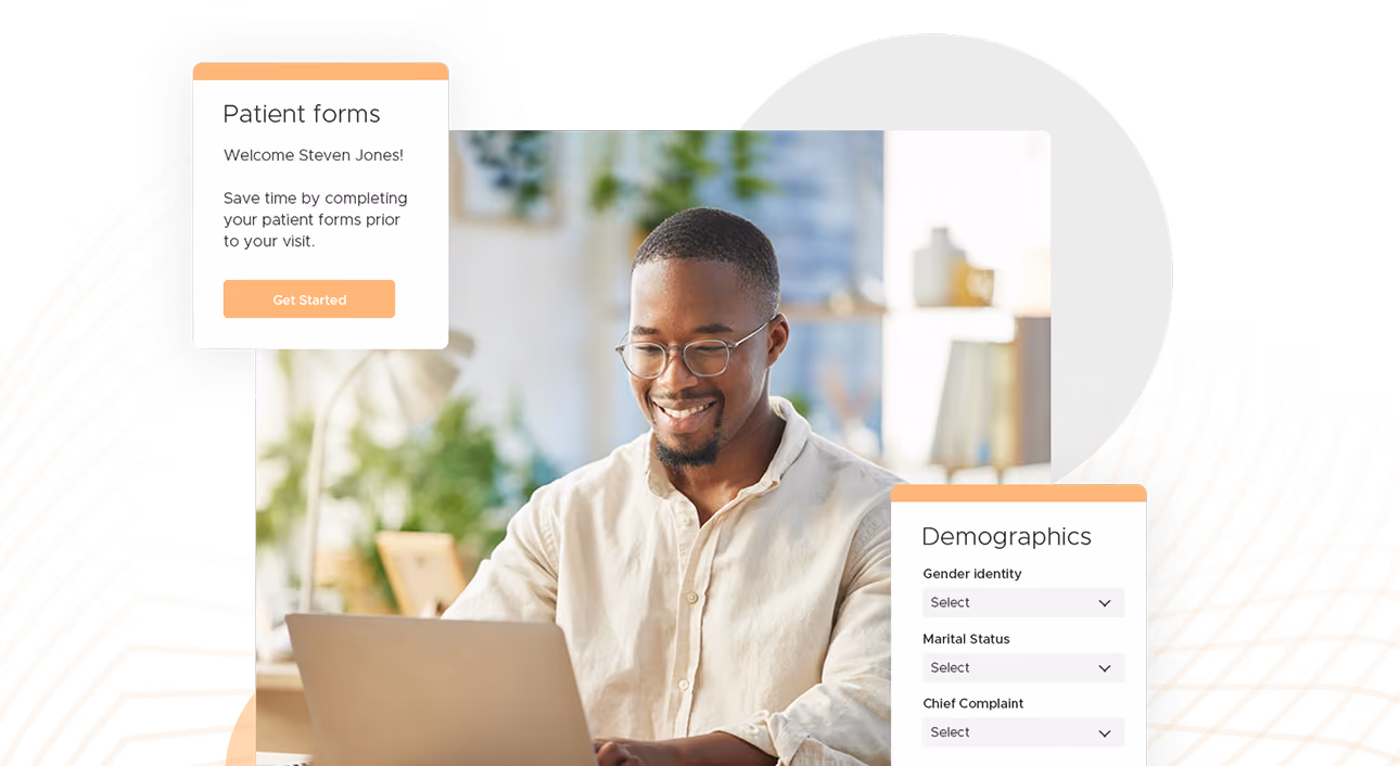 Smiling man using laptop with patient forms and demographics dropdowns on screen.