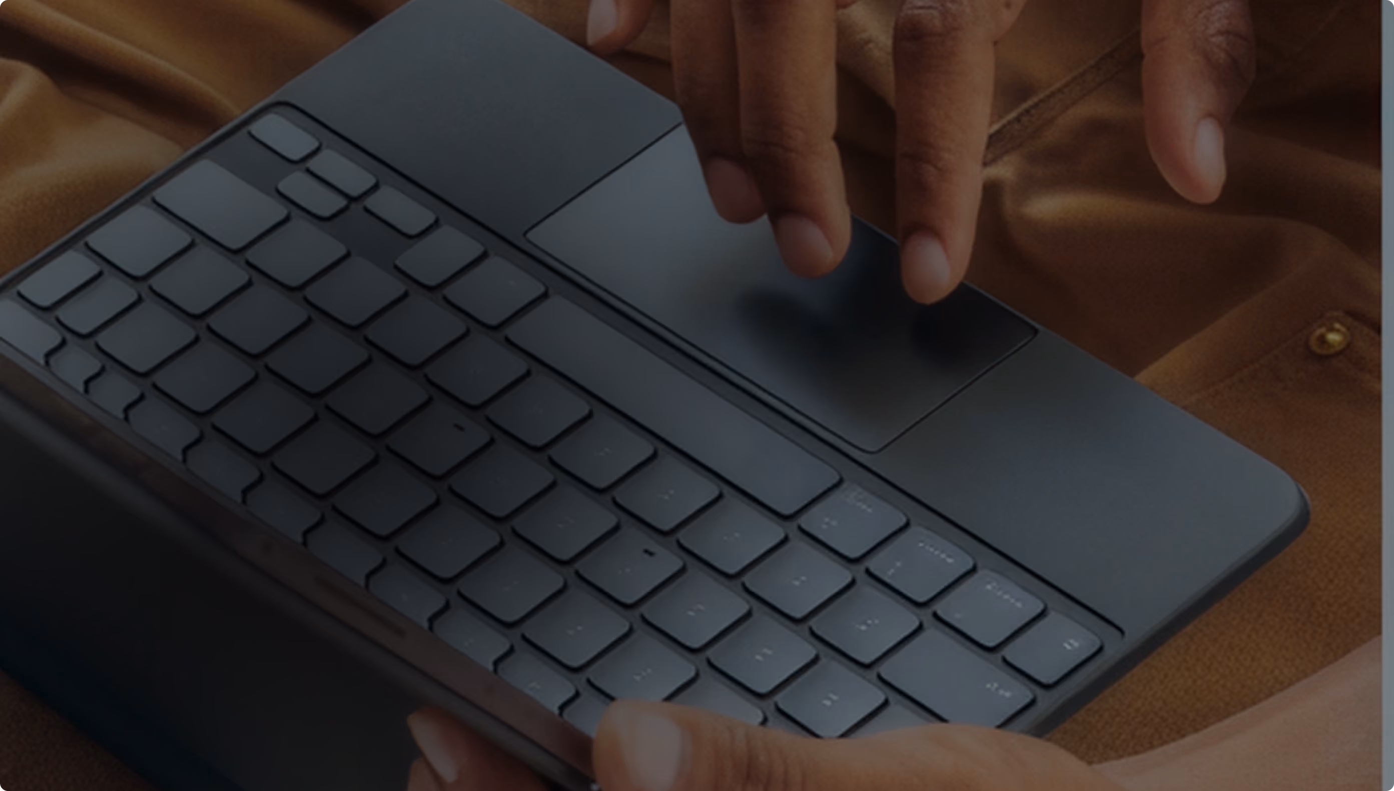 Close-up of hands typing on a detachable keyboard