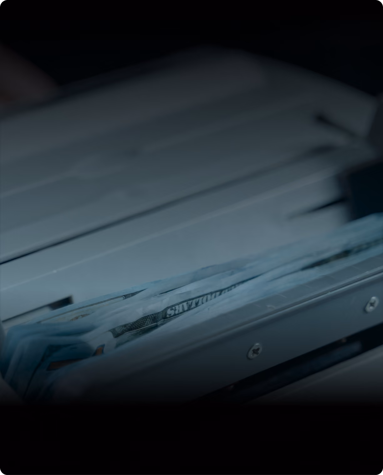 Close-up of documents feeding through a printer in low light