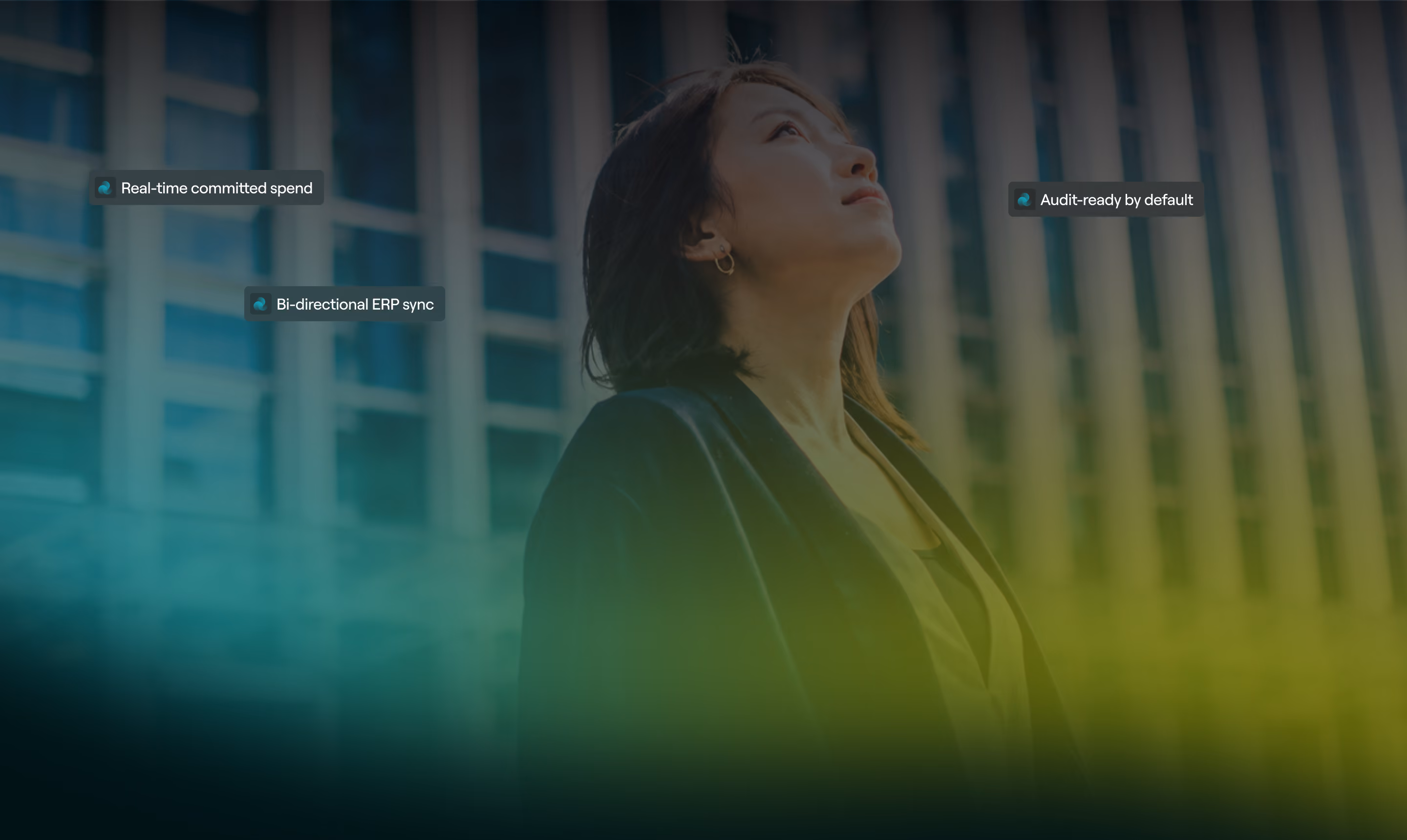 A person looking upward outside an office building, with labels reading real-time committed spend, bi-directional ERP sync and audit-ready by default