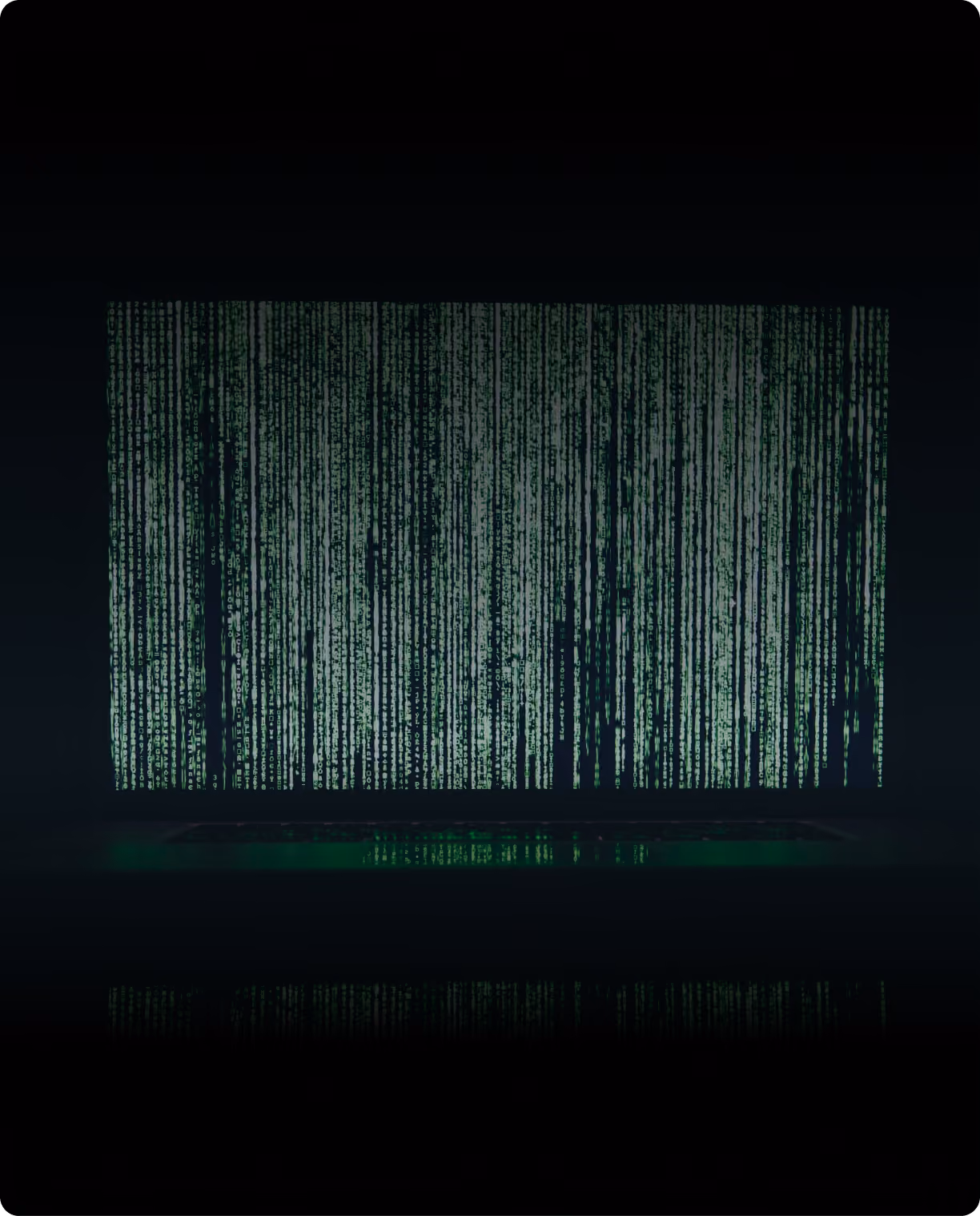 A screen filled with cascading green code in a dark room