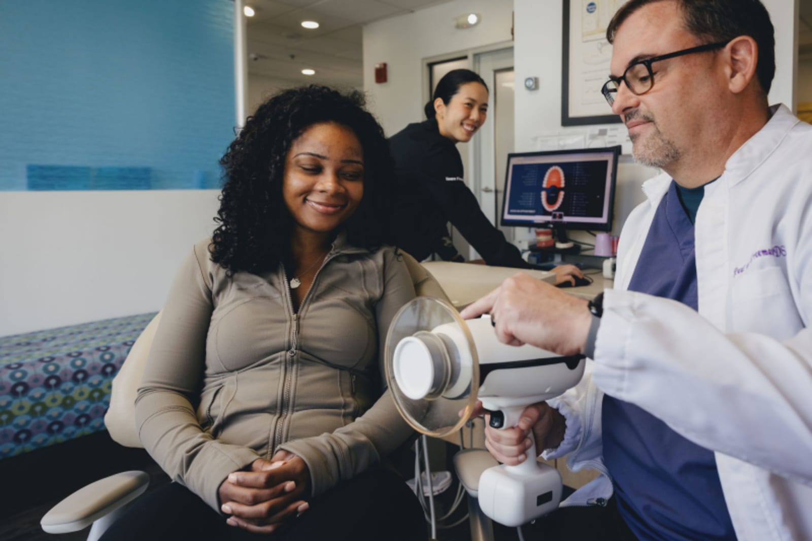 Dentist consulting with patient in waiting area, explaining treatment options