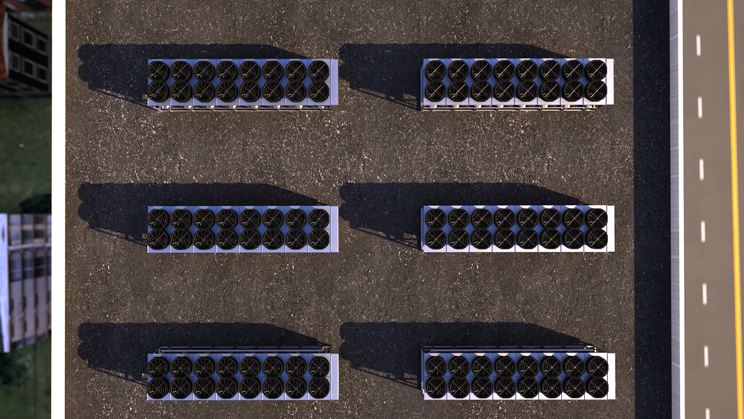 Large circular industrial ventilation fans on a rooftop with metal grates and railings.