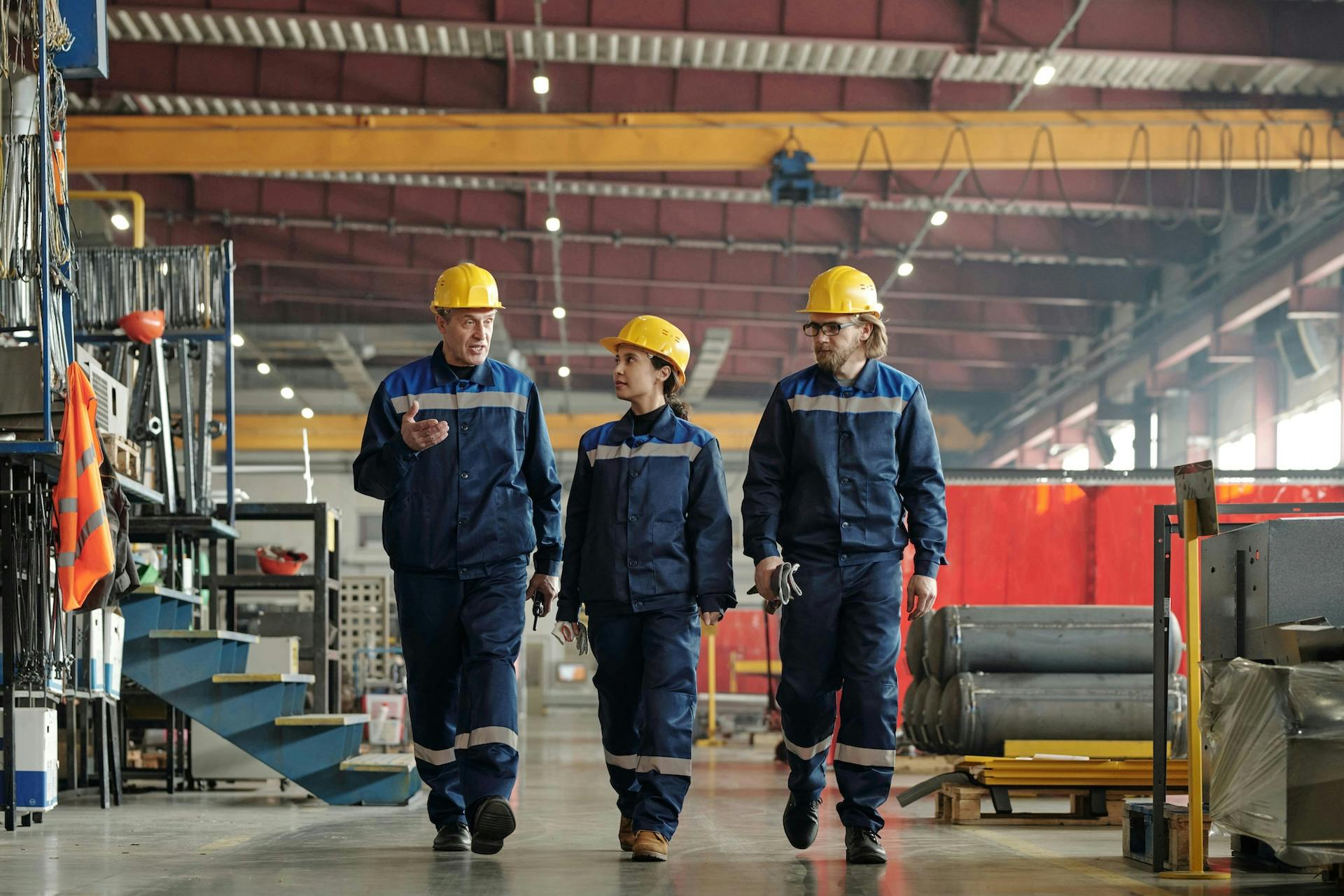 three workers walking through the warehouse