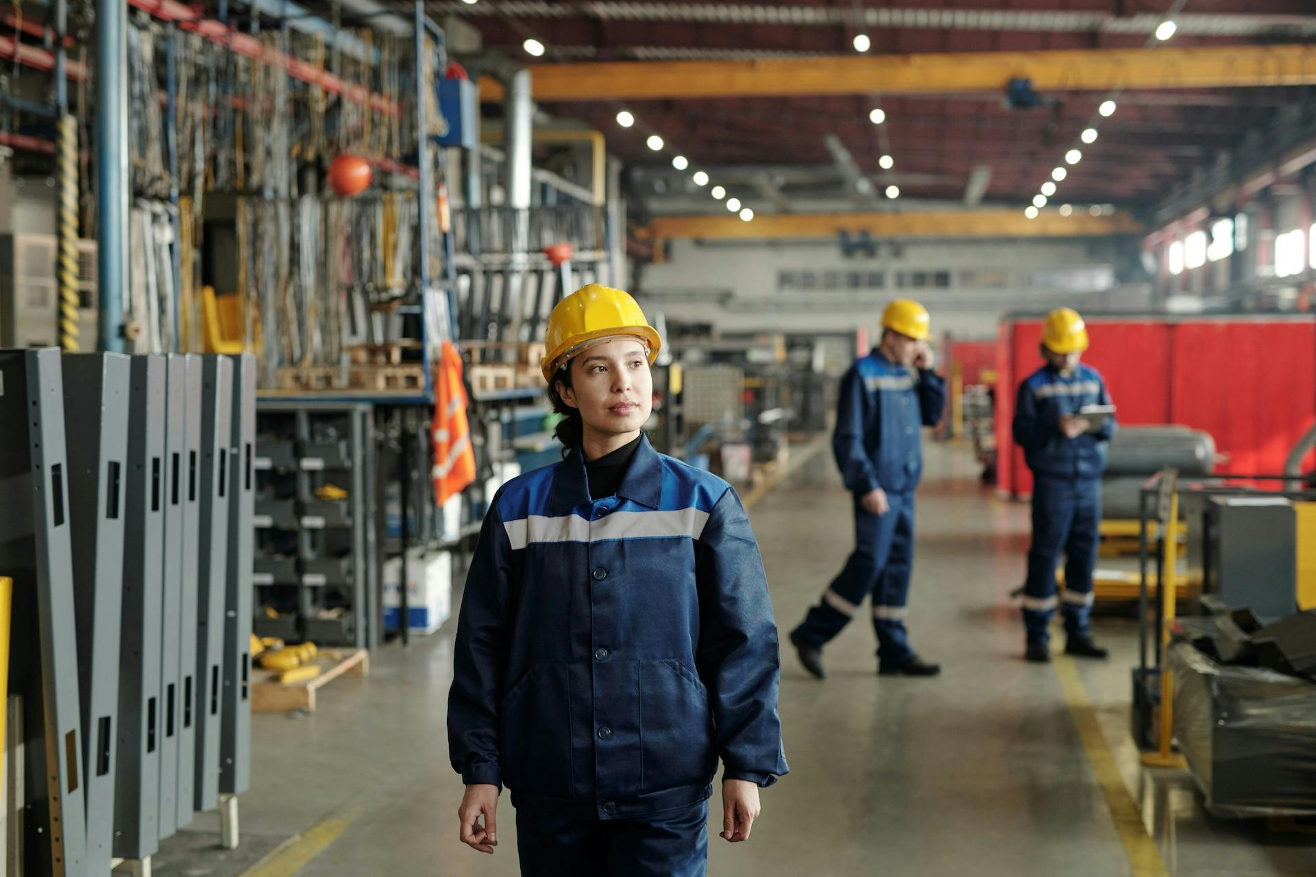 Worker in a hard hat on a manufacturing floor.
