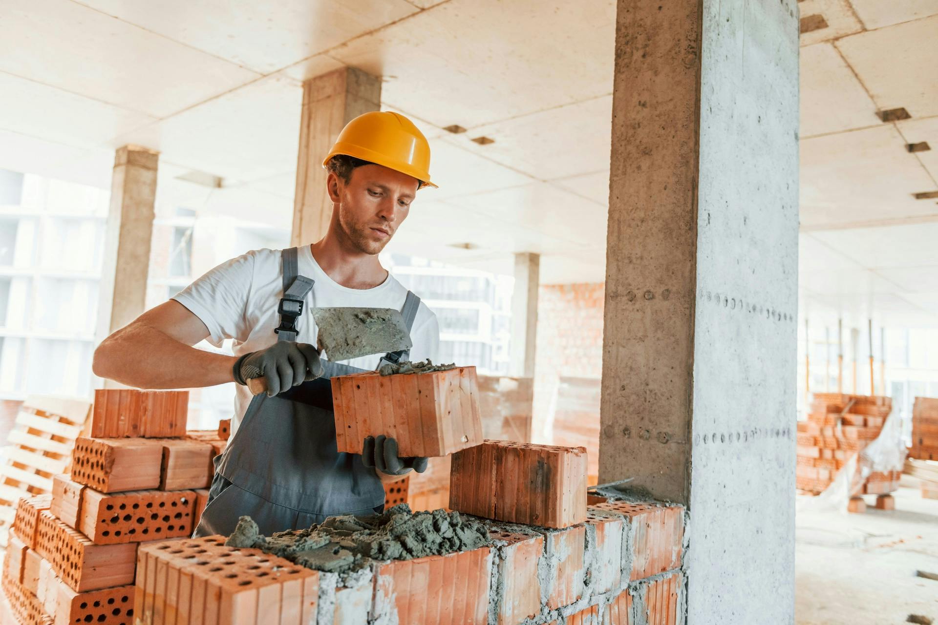 Construction worker laying bricks