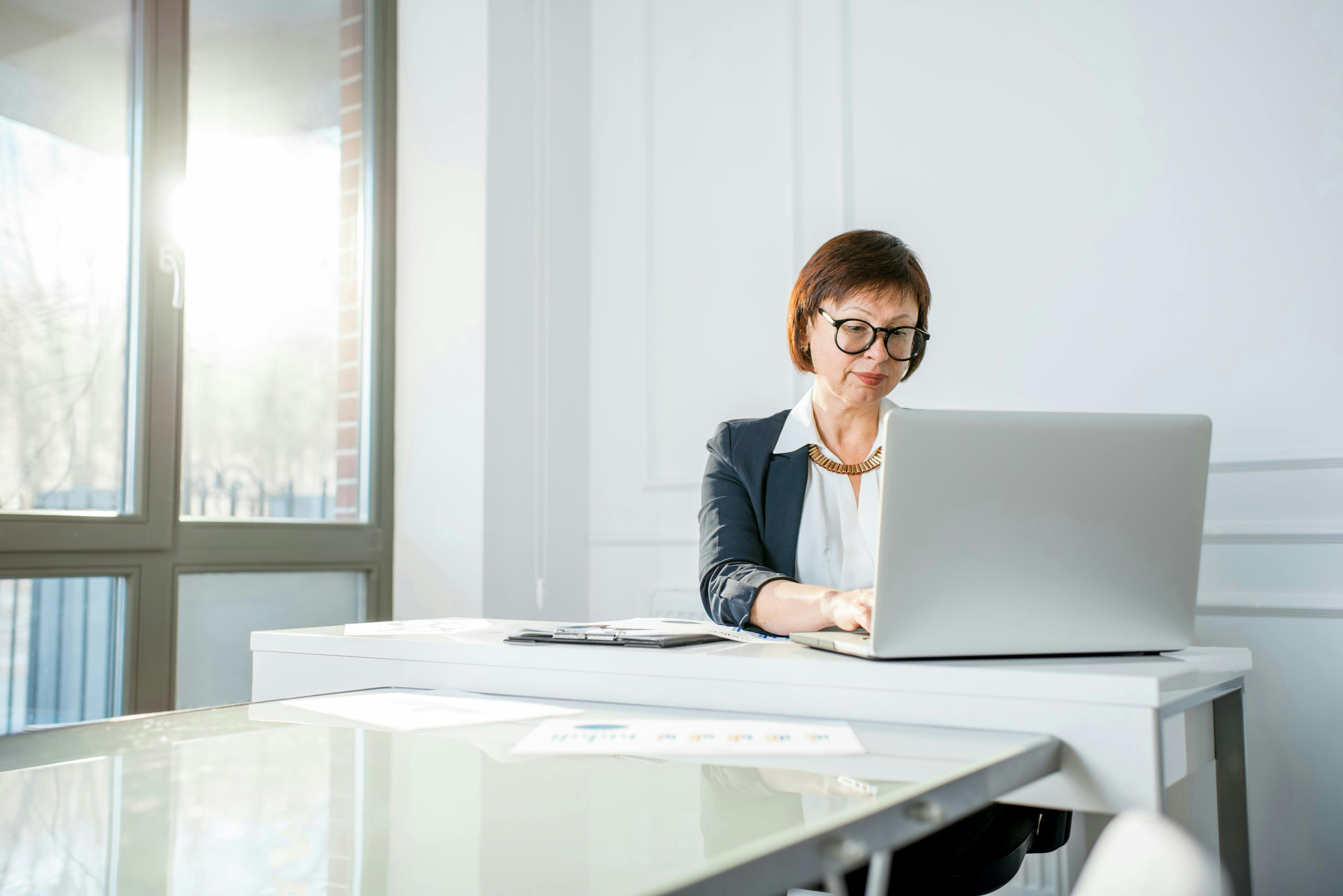 HR professional at desk working on laptop