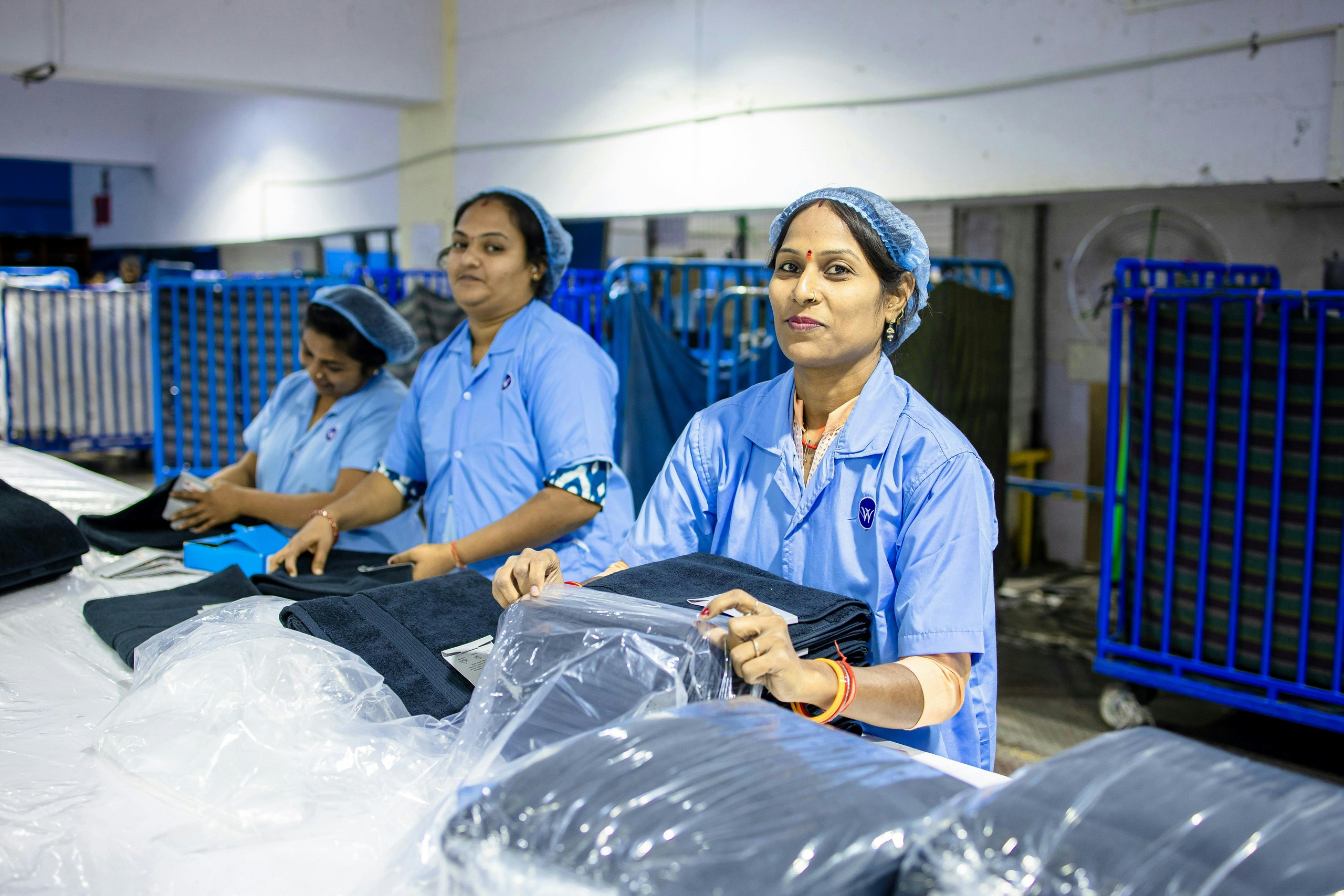 Workers packaging products on a factory floor