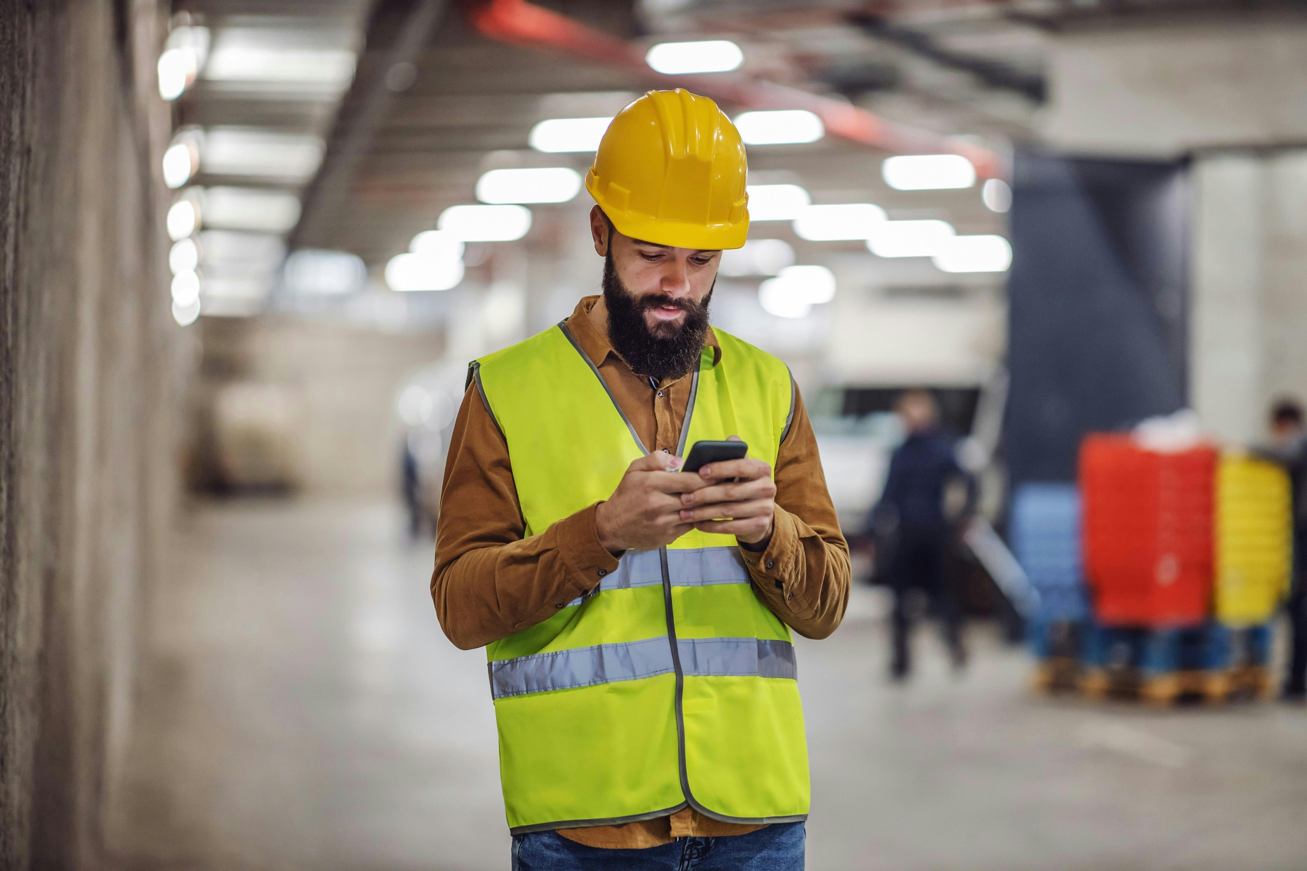 Worker texting absence report on phone
