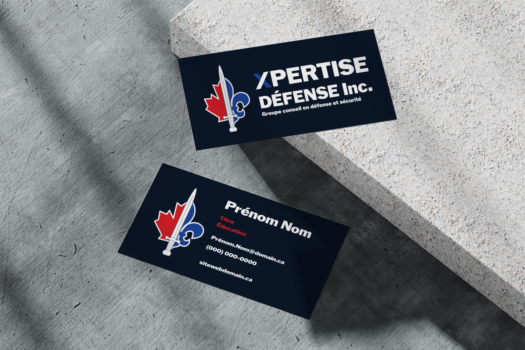 Two dark business cards for Xpertise Défense Inc. with a red maple leaf, blue fleur-de-lis, and sword logo.