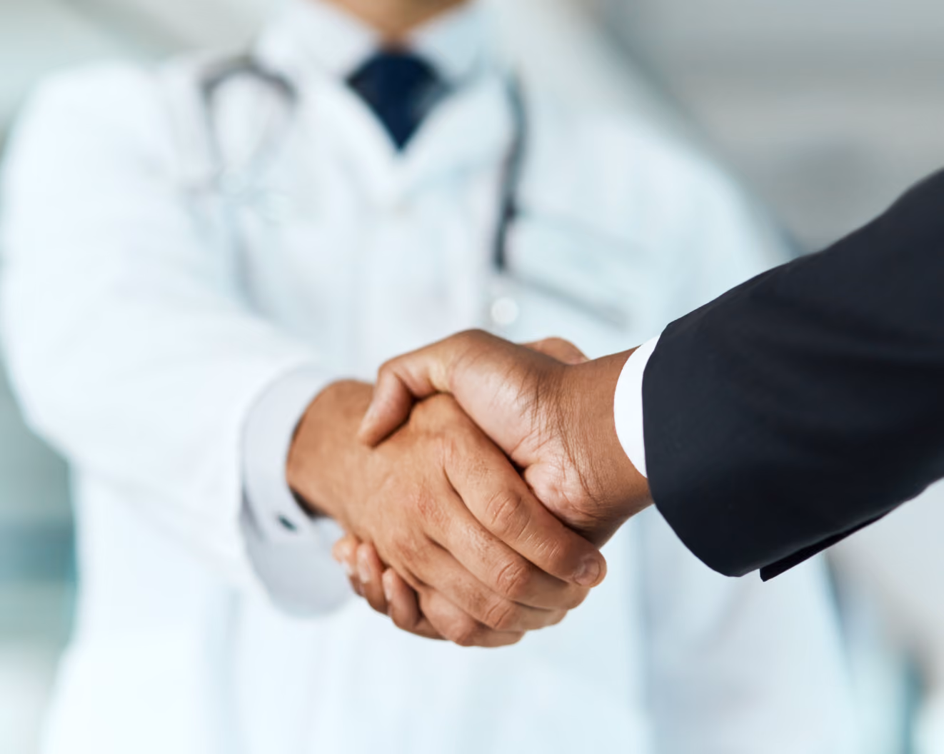 Handshake between a doctor and another person