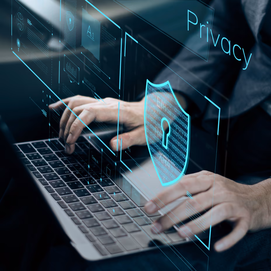 Hands typing on a laptop with a digital lock shield overlay representing cybersecurity