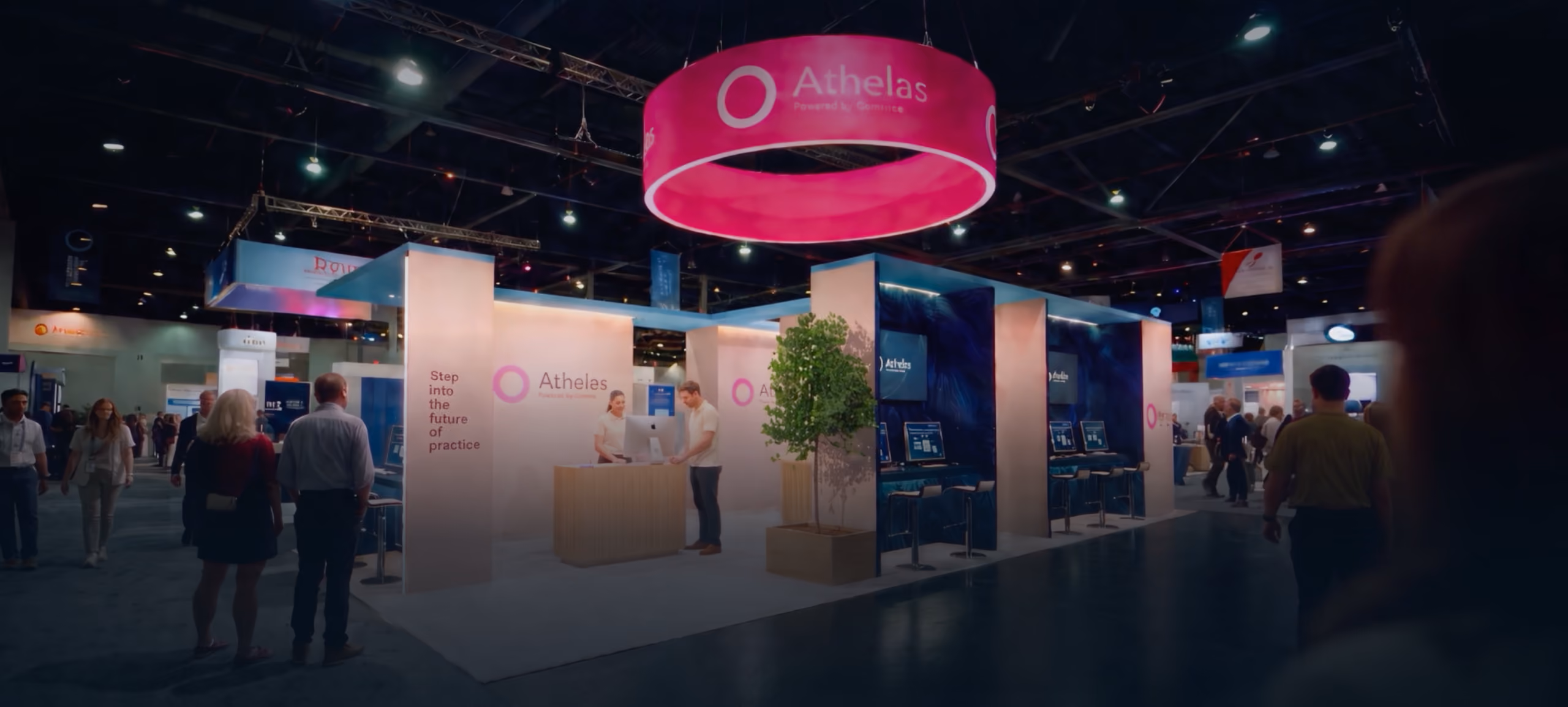 Athelas exhibition booth at PPS 2026, featuring pink signage, digital displays, and attendees.