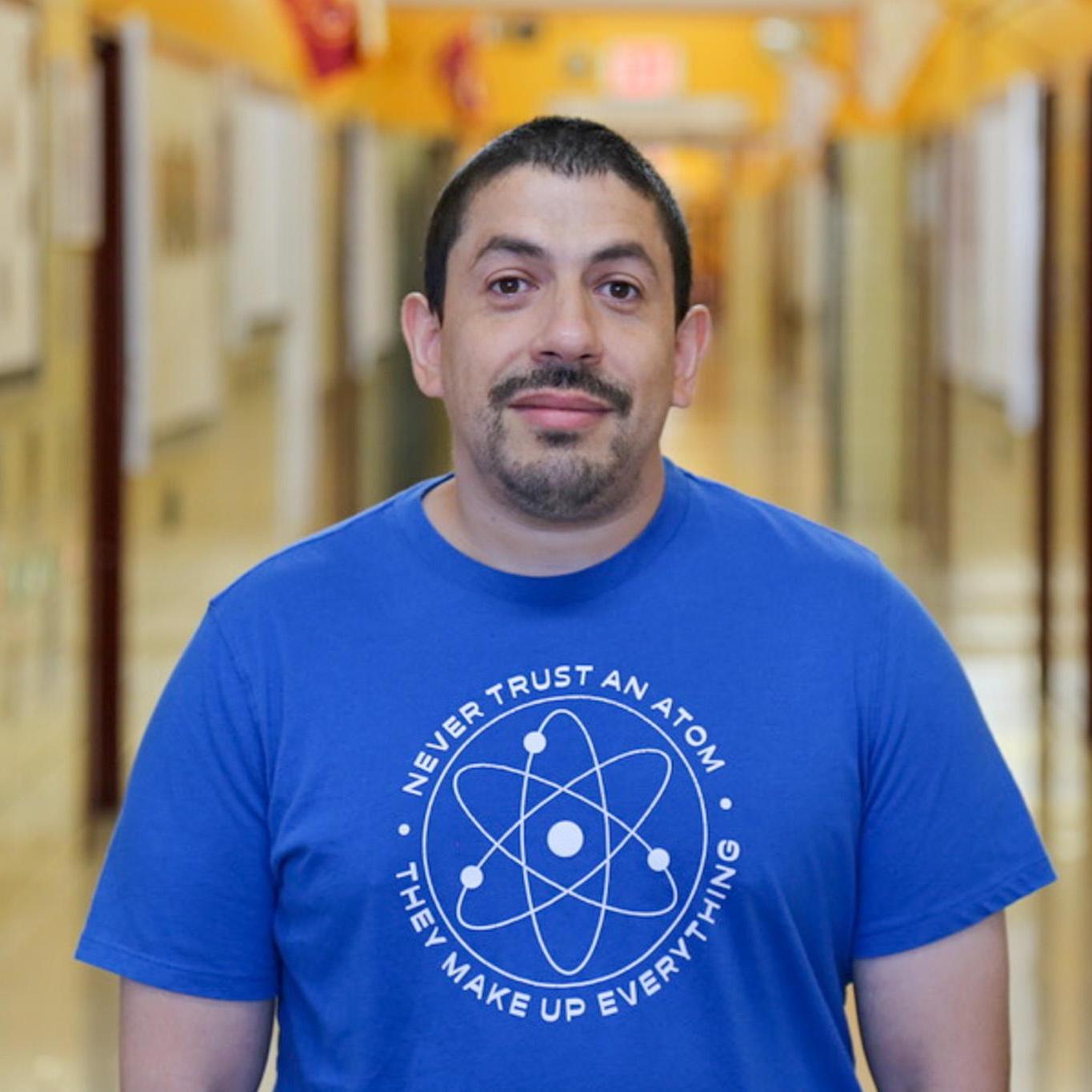Mr Alvarez science teacher standing in school hallway