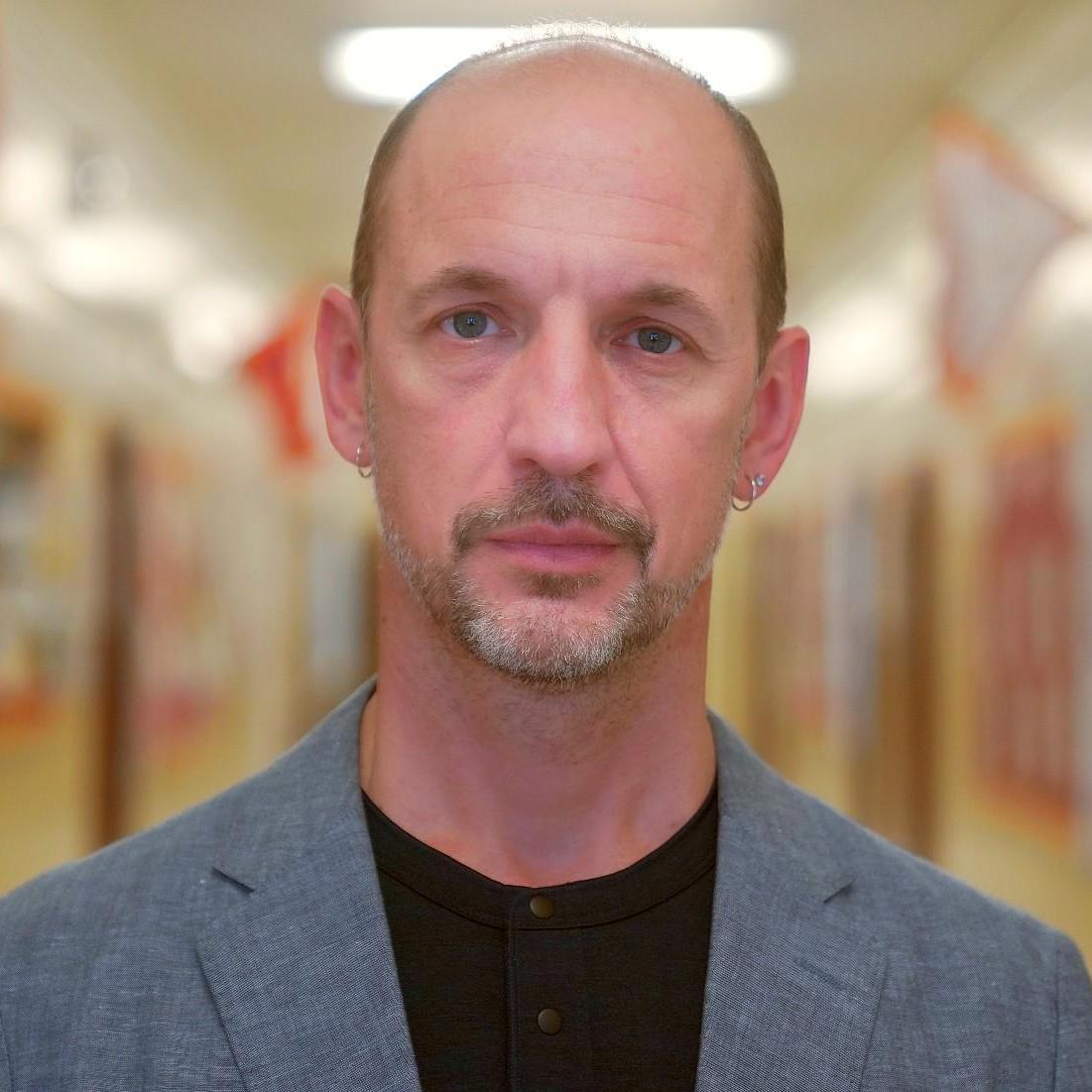 Mr. Owens staff portrait in school hallway
