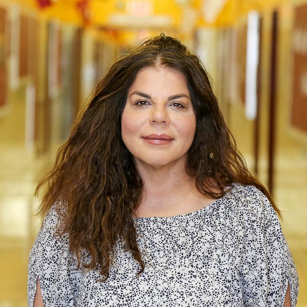 Ms. Pashalis staff portrait in school hallway
