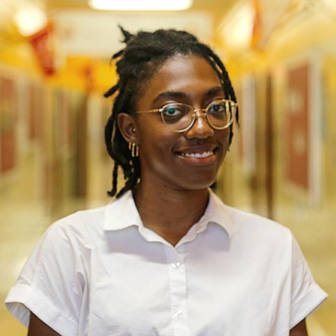 Ms. Weeks smiling in a school hallway
