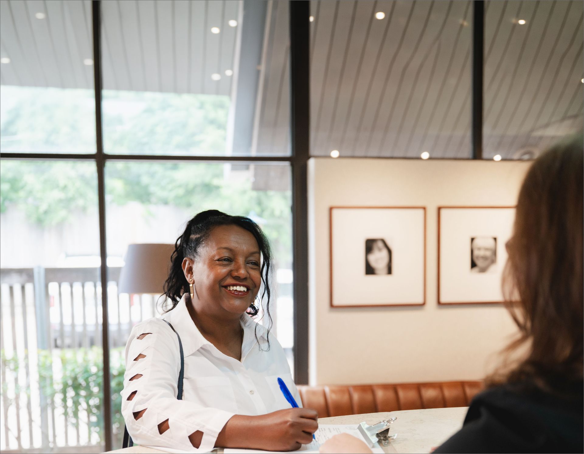 Smiling patient signing in at the Greene & Ratcliff front desk.