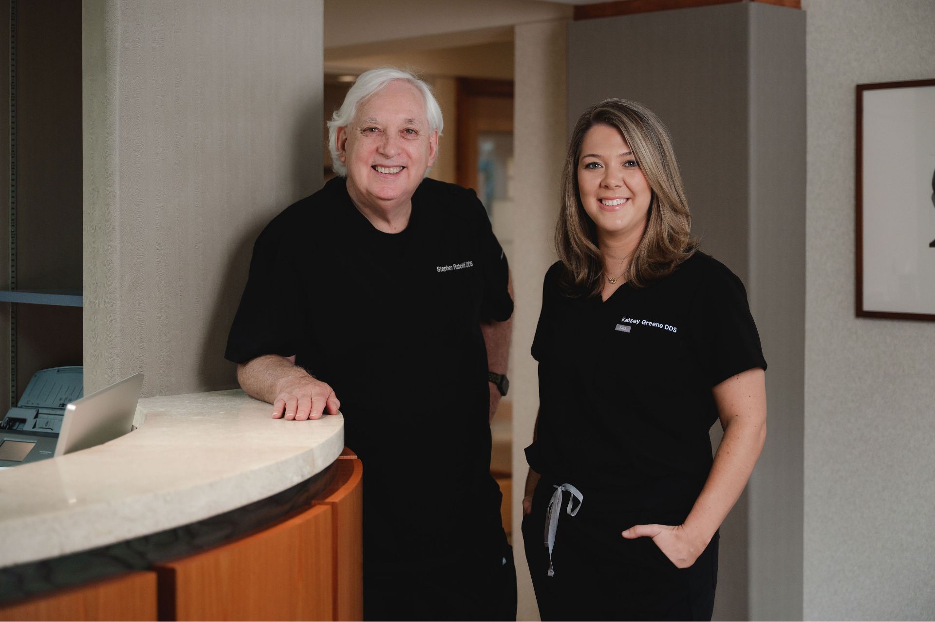 Dr. Ratcliff standing with a team member near the front desk.