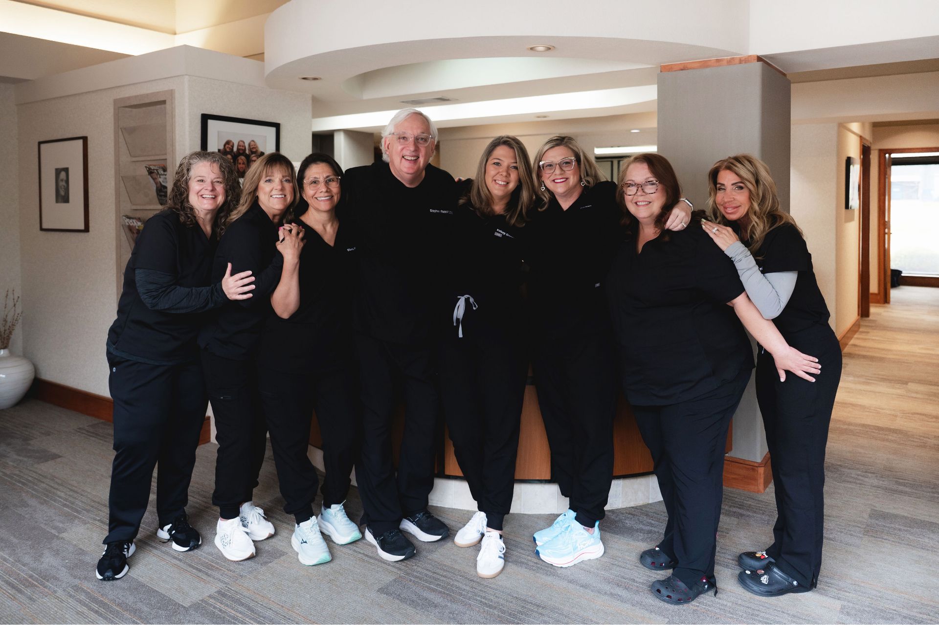 Greene & Ratcliff team of eight staff members posing together in the office lobby.