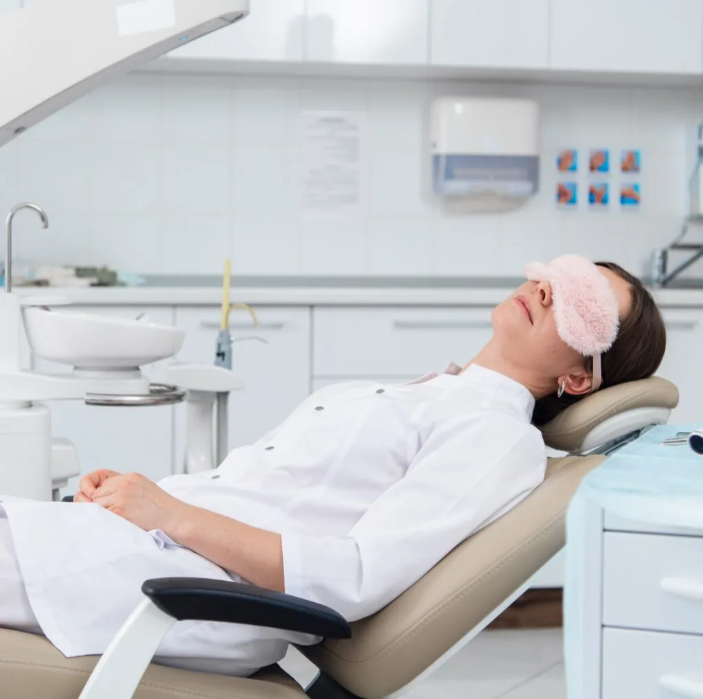 Patient napping in the chair following administration of oral conscious sedation.