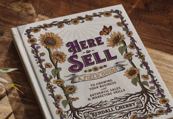 Book titled 'Here to Sell: A Field Guide to Growing Your Business with Authentic Sales & Marketing Skills' by Kendall Cherry, featuring a cover design with sunflowers and a butterfly on a wooden surface.