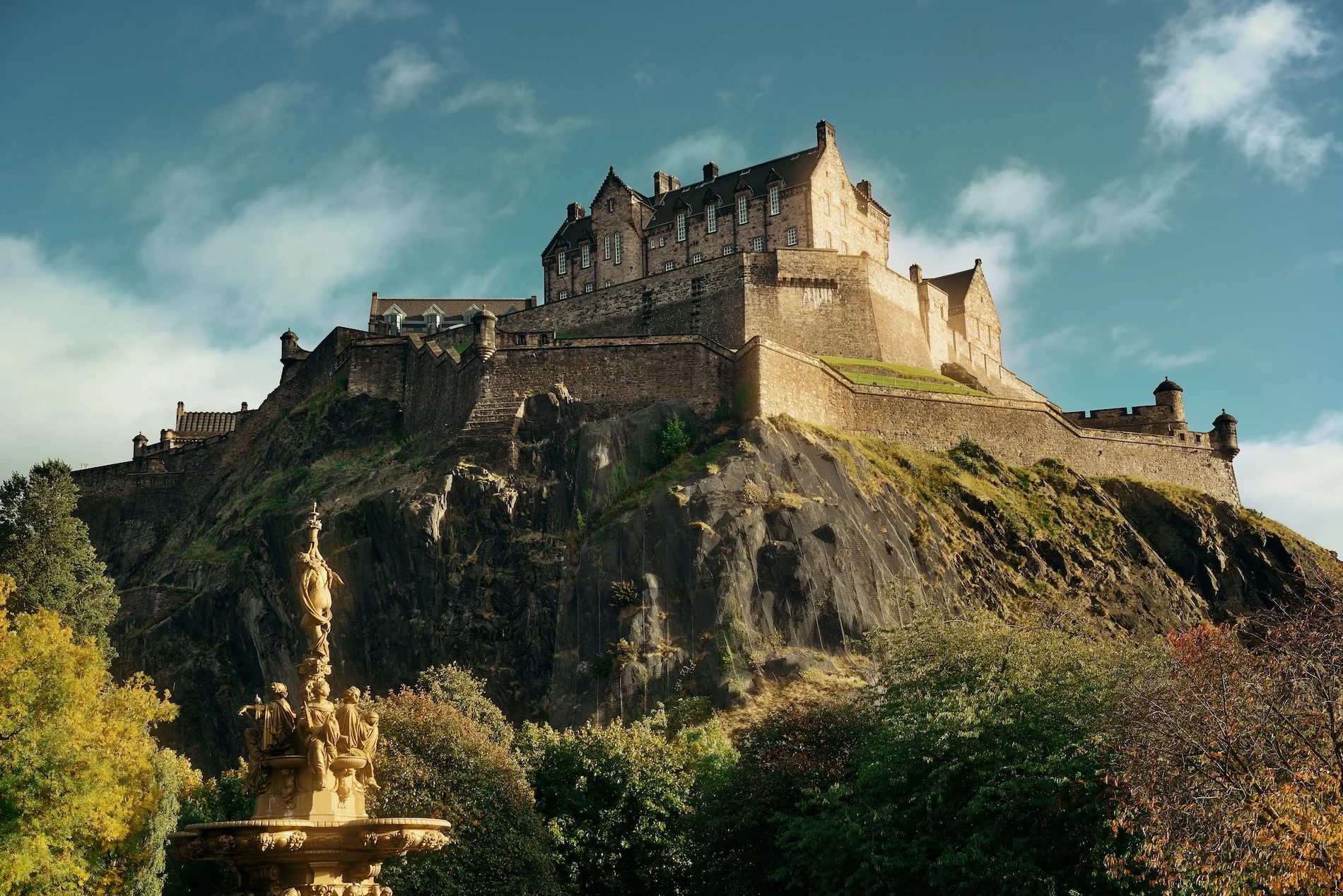 Edinburgh Castle perched on rocky volcanic crag with blue sky