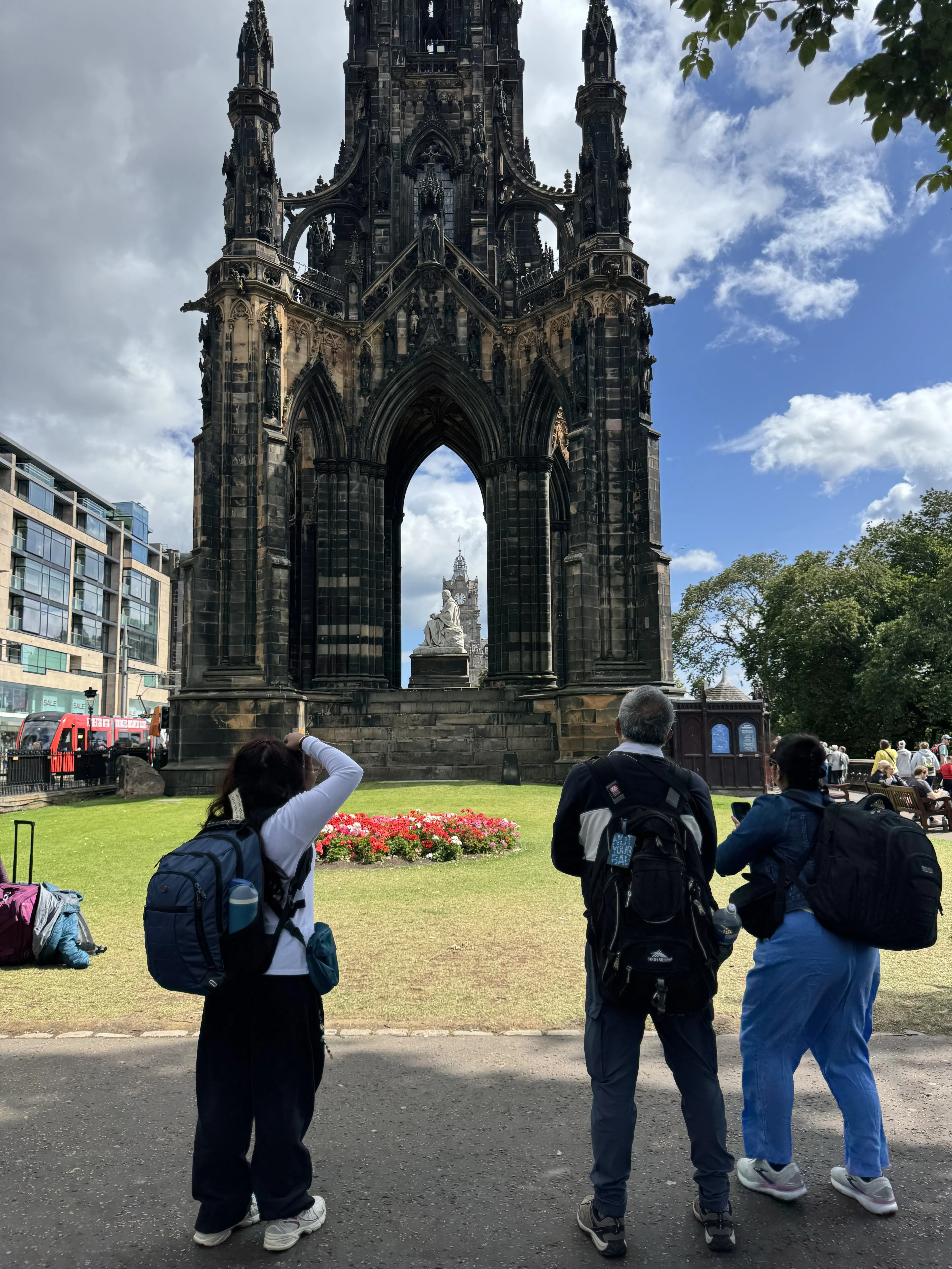 Tourists photographing the Scott Monument in Edinburgh city center