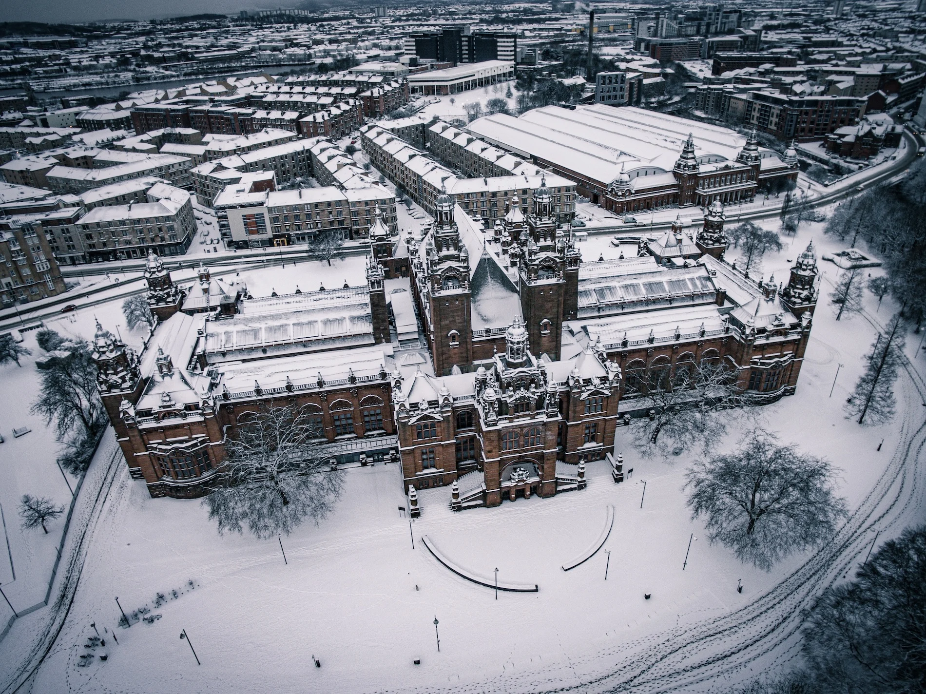 Aerial view of Glasgow University campus covered in snow during winter.