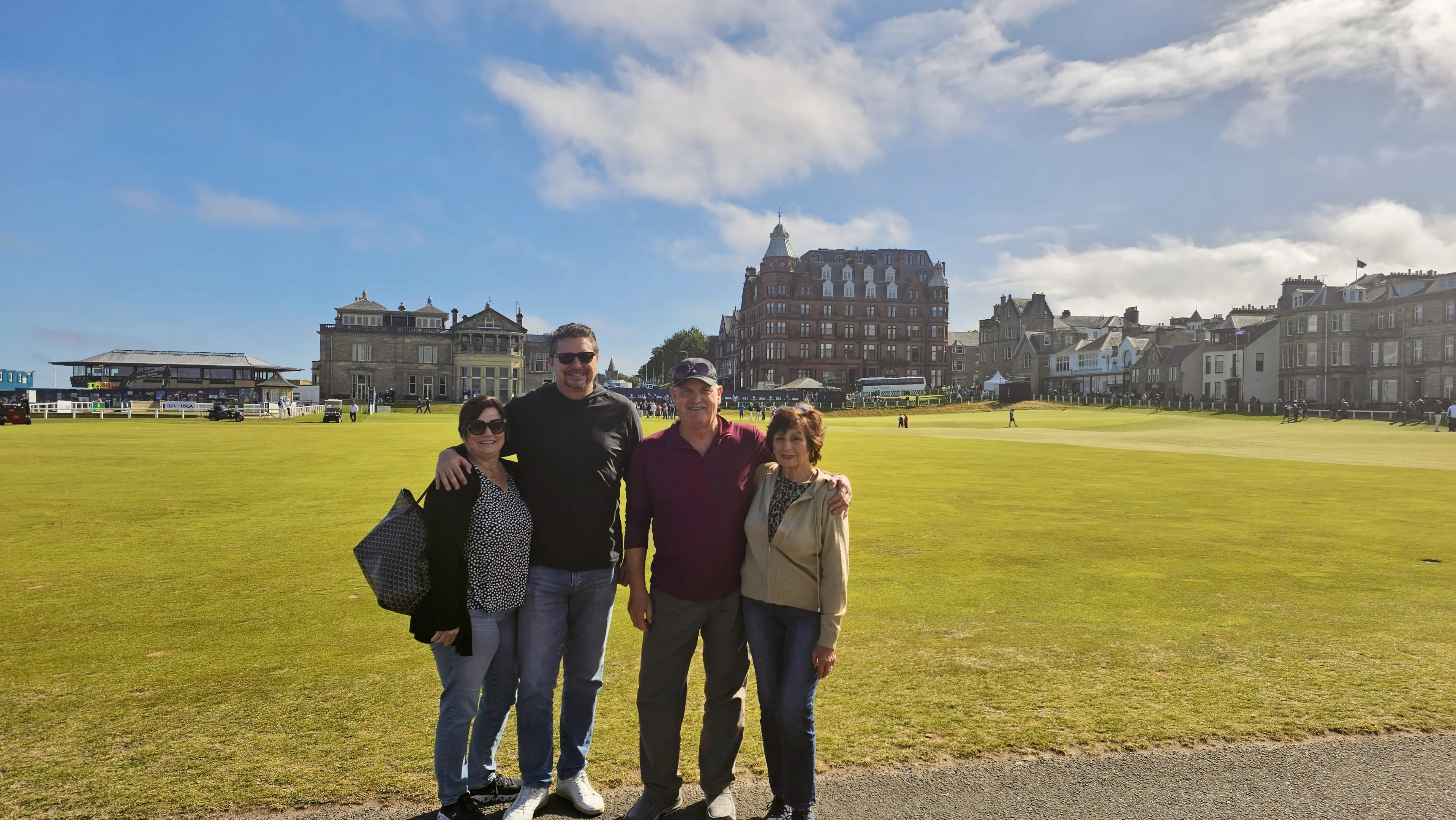 Group of four people posing on the Old Course at St Andrews, Scotland