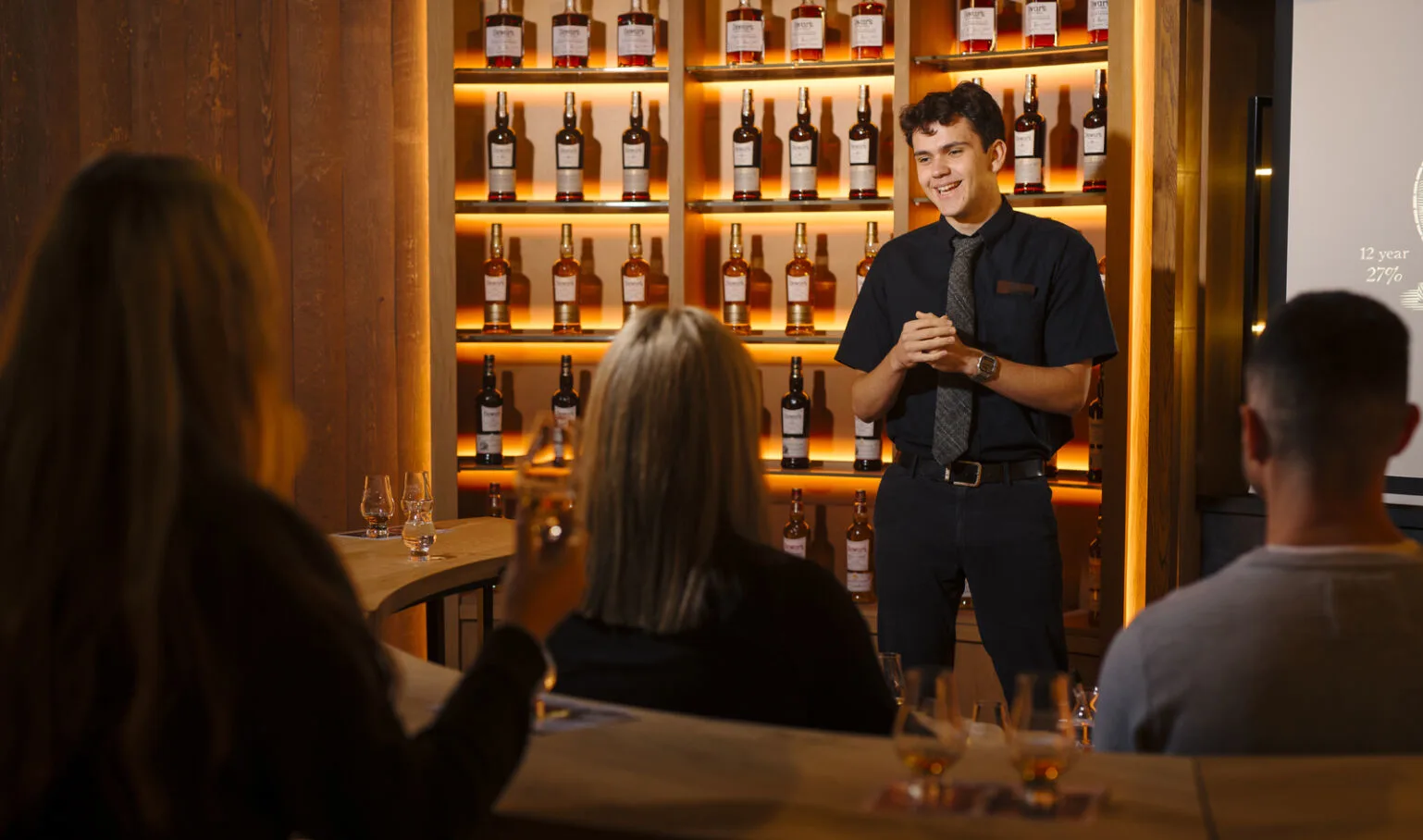 Staff member giving whisky tasting presentation to tour group