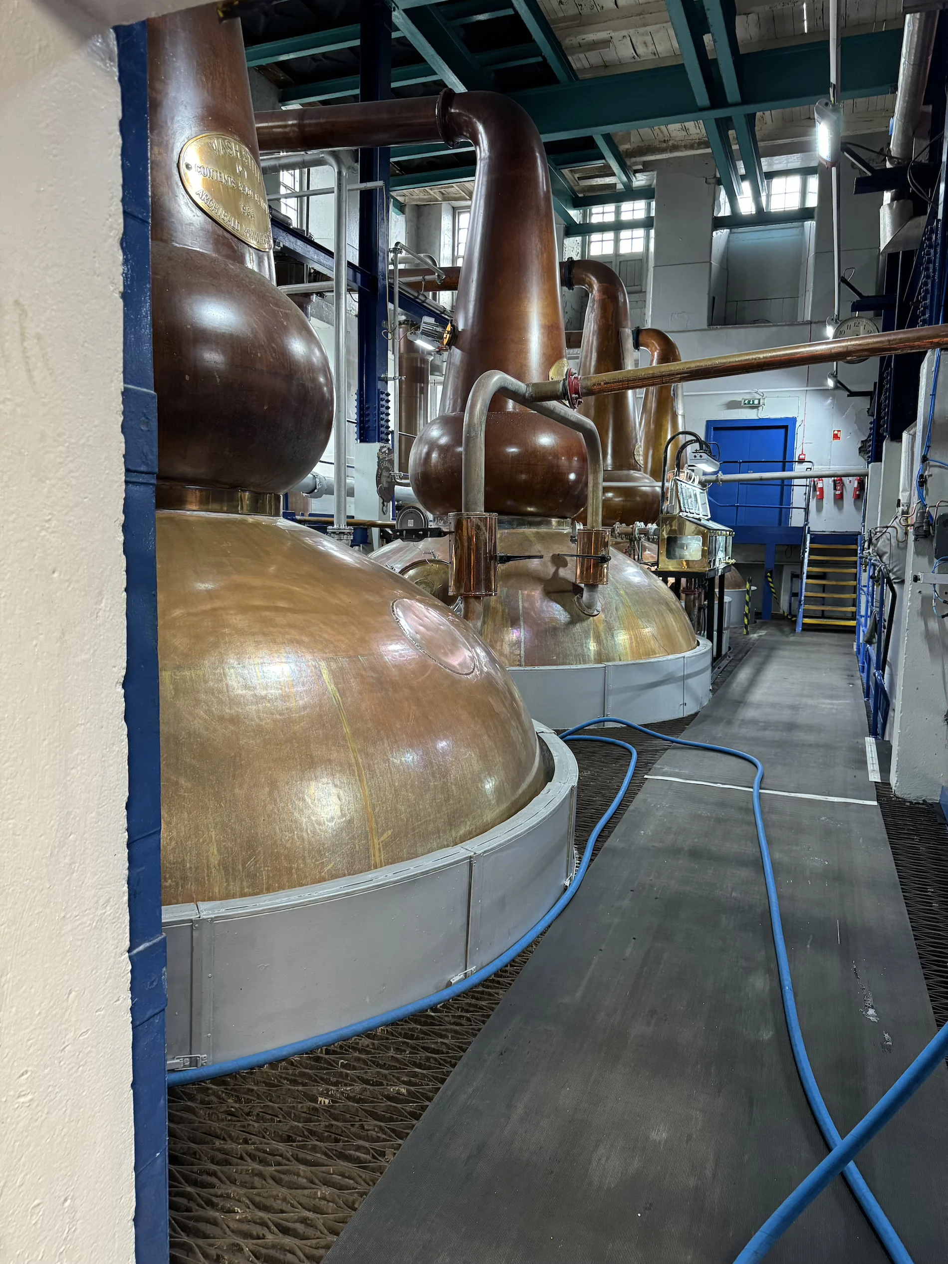 Copper whisky stills in a Scottish distillery production facility